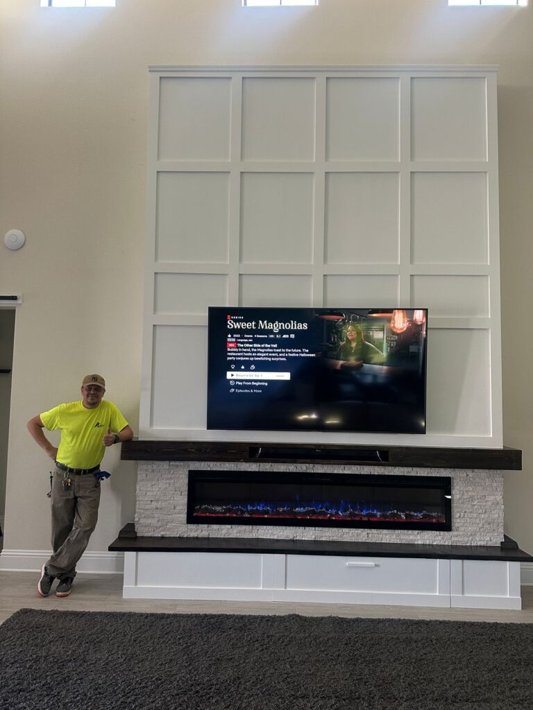 Custom white shiplap fireplace wall with floating mantel and electric fireplace in Florida