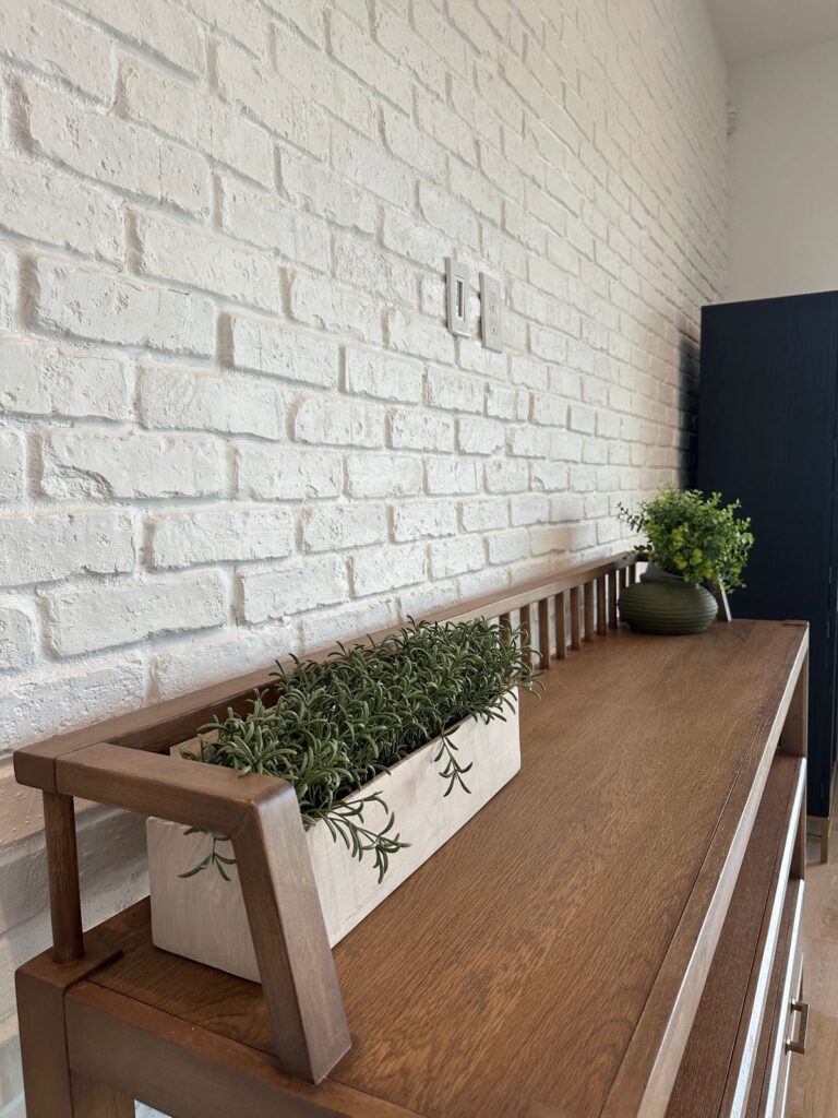 Custom Accent Wall Design with Brick Texture Modern accent wall with white painted brick texture and custom wood console table design
