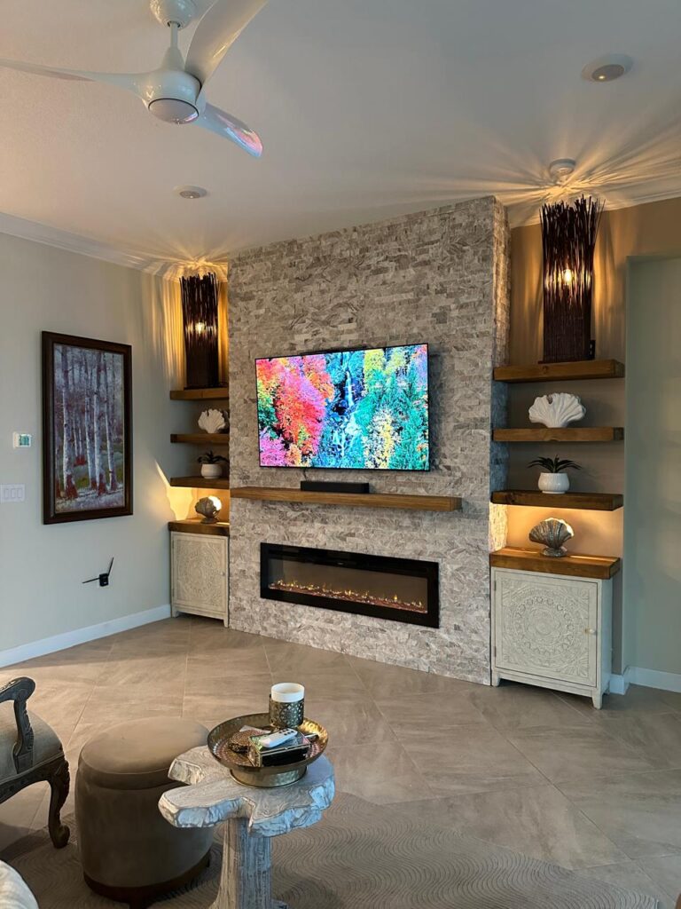 Custom Stone Fireplace TV Wall With Floating Shelves custom stone fireplace TV wall with floating wood shelves ambient LED lighting and linear fireplace