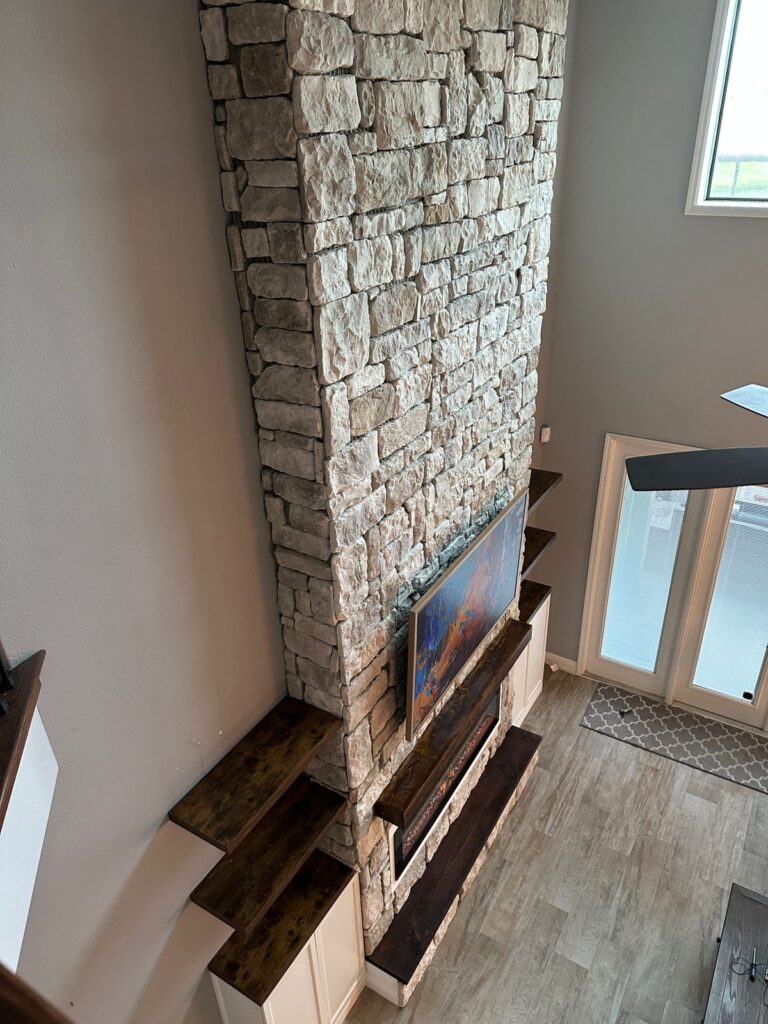full height stone fireplace wall with floating mantel