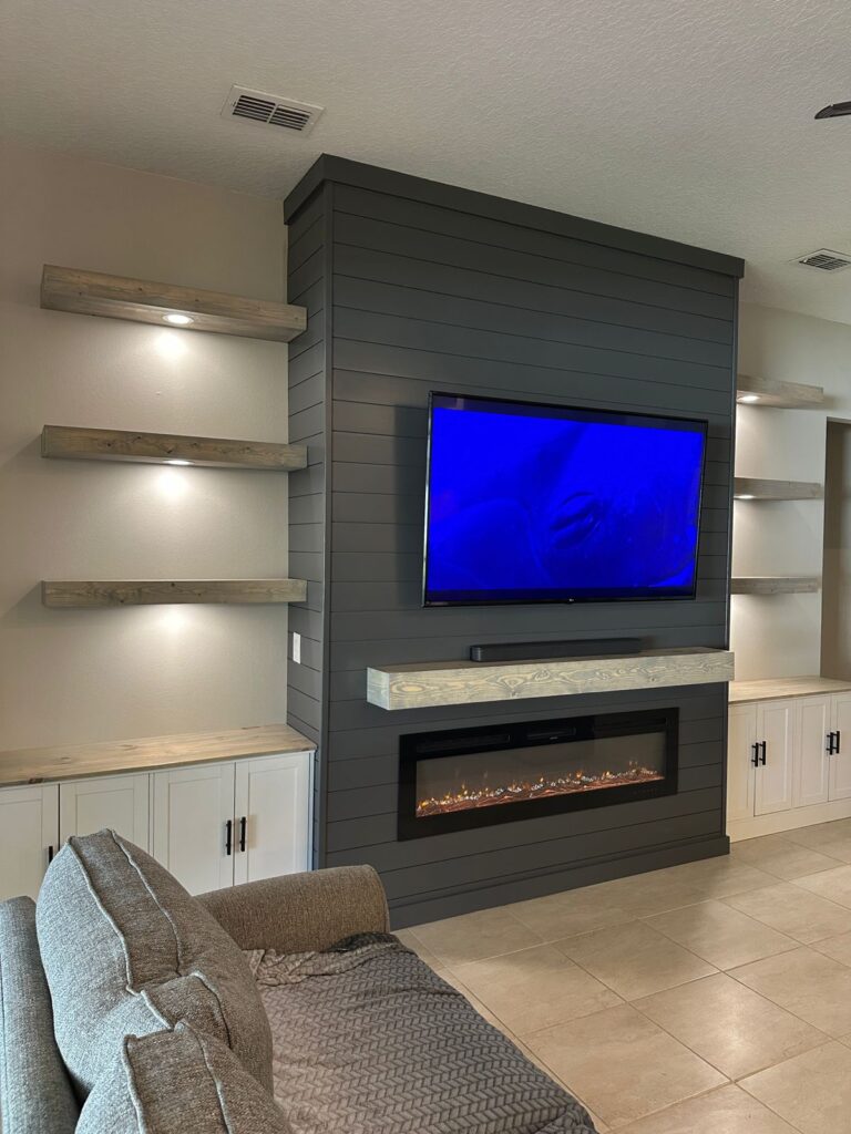Custom Fireplace TV Wall With Floating Shelves custom shiplap fireplace TV wall with floating shelves and built-in cabinetry