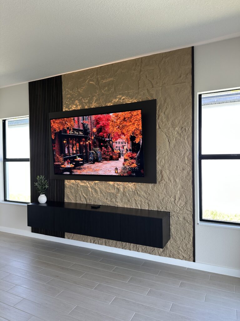 Modern Floating TV Wall with Stone Finish Modern floating TV wall with stone finish floating cabinet and vertical wood slat accent design