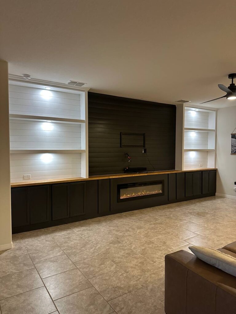 Custom Fireplace TV Wall With Built-In Cabinets custom fireplace TV wall with black built-in cabinets LED shelving and linear fireplace