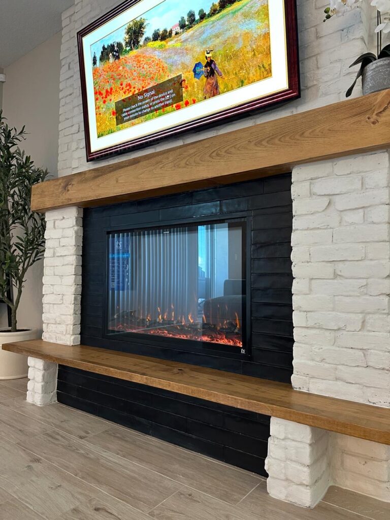 Custom linear fireplace wall with stone finish, floating wood mantel, recessed electric fireplace, and modern entertainment wall design in Florida.
