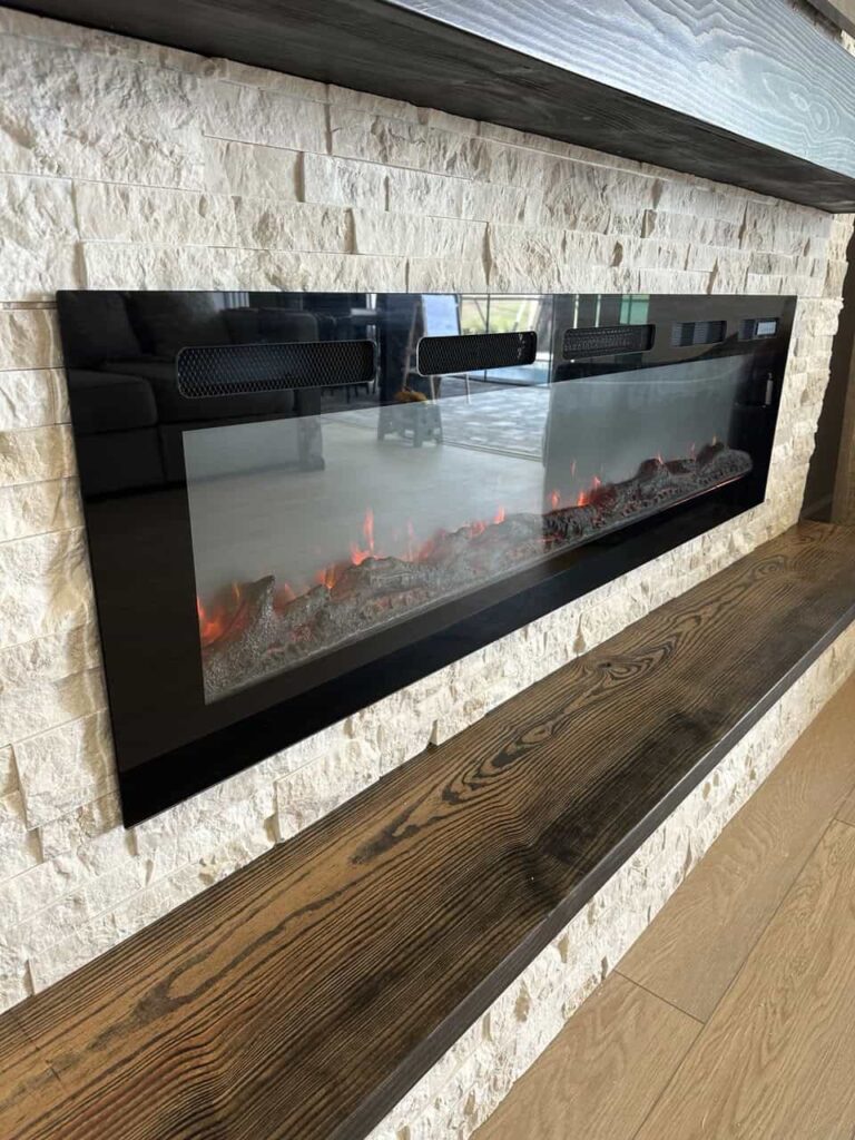 Linear Electric Stone Fireplace Detail close-up linear electric fireplace with modern stone wall texture and floating mantel