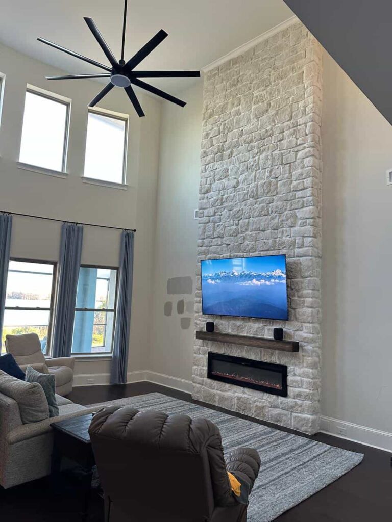 Modern Smooth Stone Fireplace Wall modern smooth black stone fireplace wall with floating wood mantel and built-in shelving