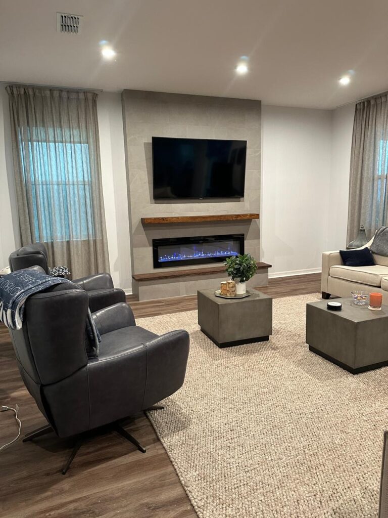 Modern porcelain tile fireplace wall with TV, linear electric fireplace, wood mantel, and floating bench