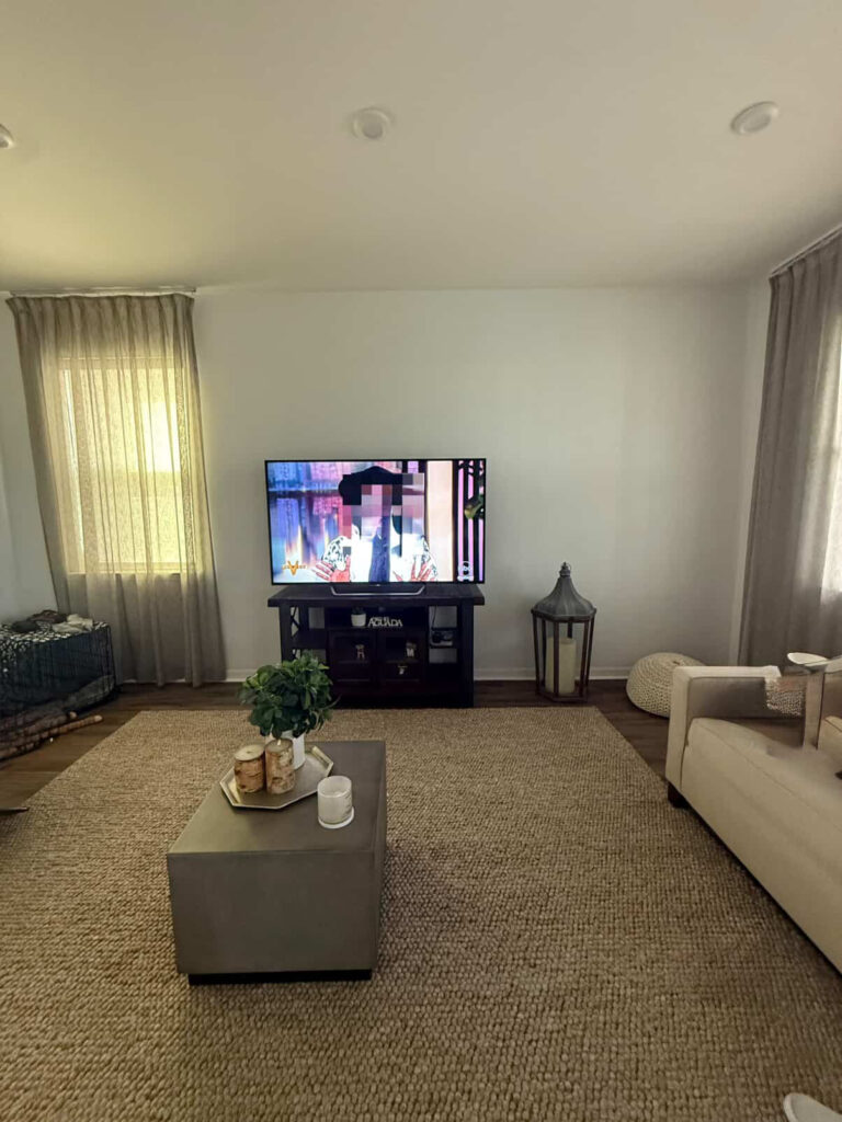 Living room before custom modern porcelain tile fireplace wall installation