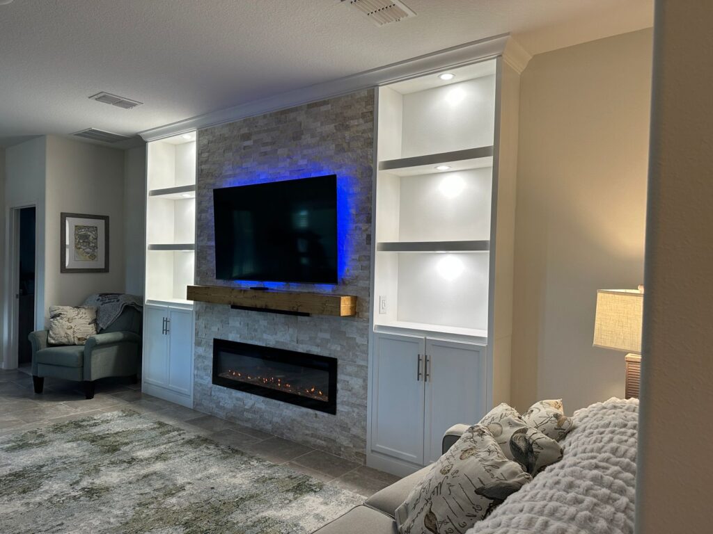 Linear electric fireplace detail on classic stone fireplace wall with floating wood mantel