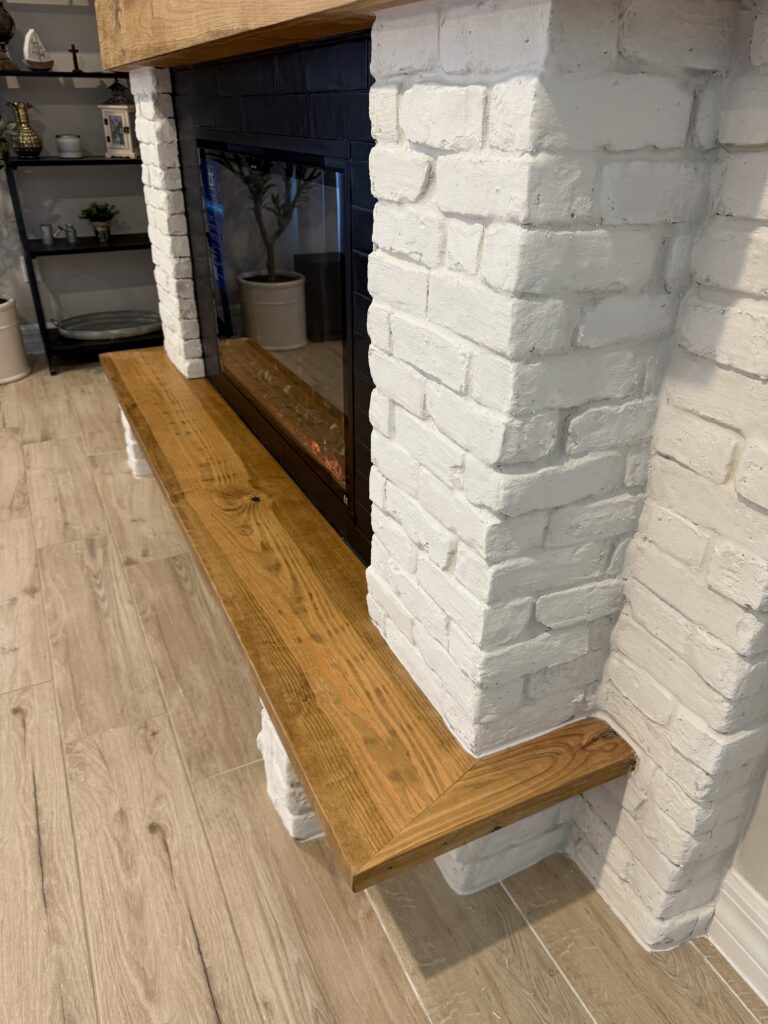Custom floating wood bench detail on white brick fireplace wall with Old Chicago brick finish
