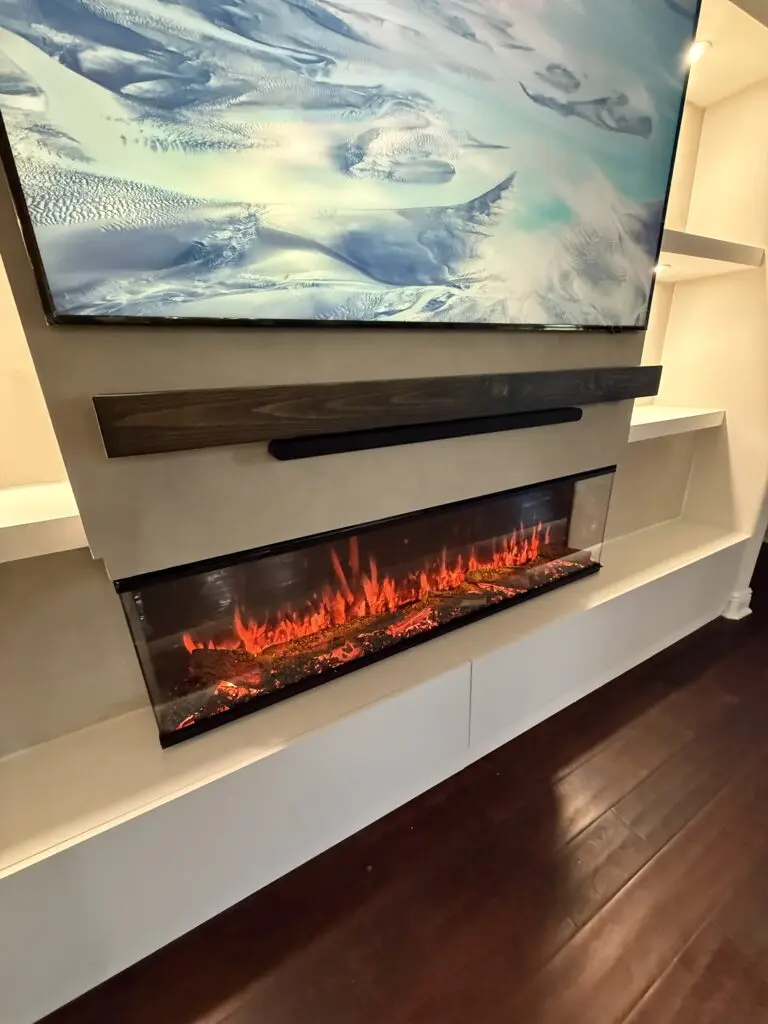 Limewash fireplace TV wall with floating mantel, soundbar area, 3D electric fireplace, and built in shelving
