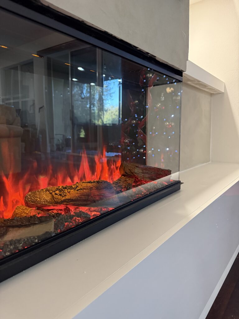 3D electric fireplace detail on limewash fireplace TV wall with built in shelving and hidden storage