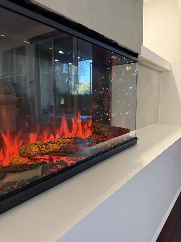 3D electric fireplace detail on limewash fireplace TV wall with built in shelving and hidden storage