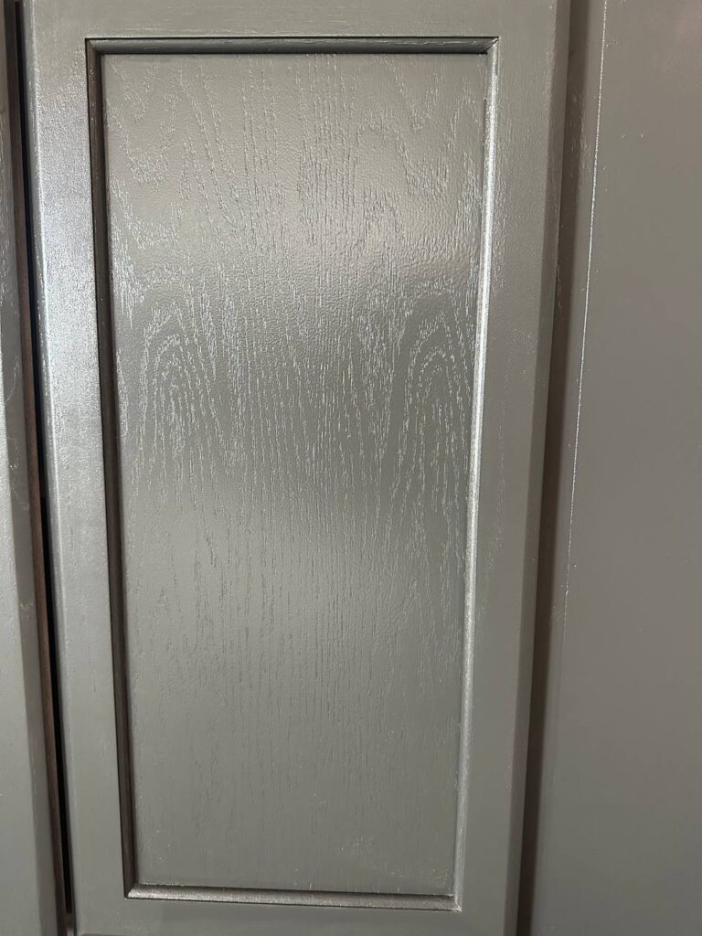 Dark cabinet door detail on custom fireplace TV wall with cabinets