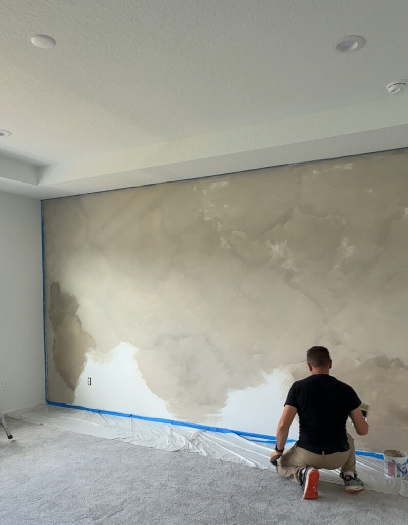 Minimal limewash accent wall installation with hand-applied mineral finish in bedroom