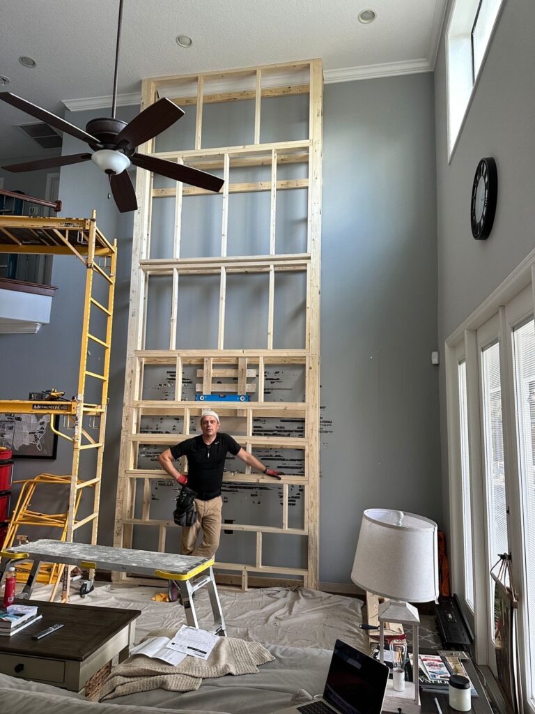 18-foot fireplace wall framing for full-height limestone stone installation with custom entertainment wall layout
