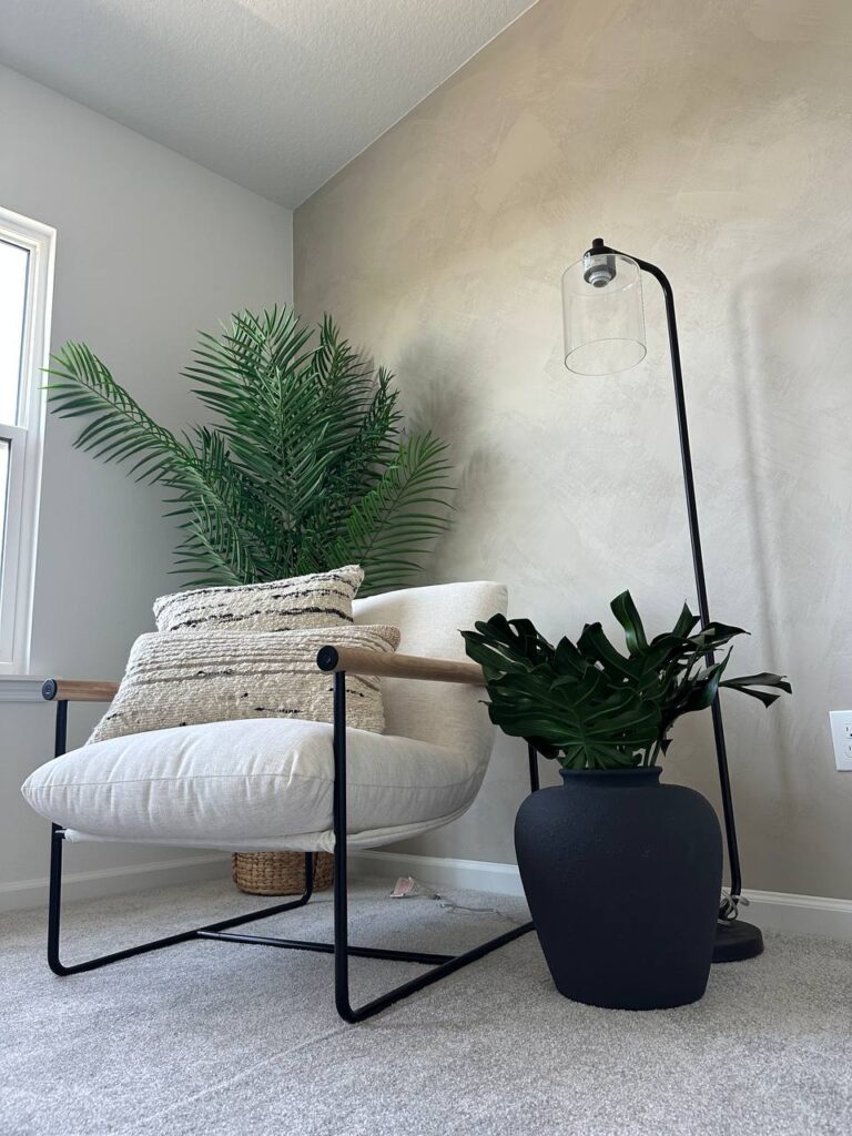 Soft limewash accent wall detail with modern chair, floor lamp, and indoor plants