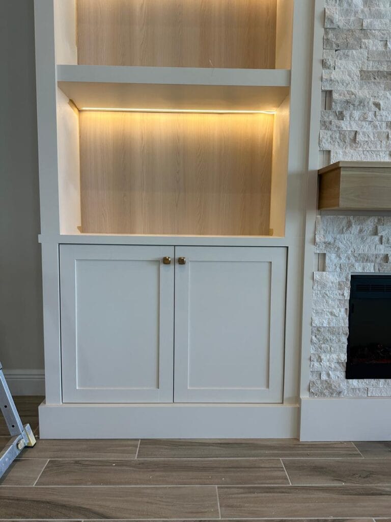 Textured stone fireplace wall with floating mantel and electric fireplace