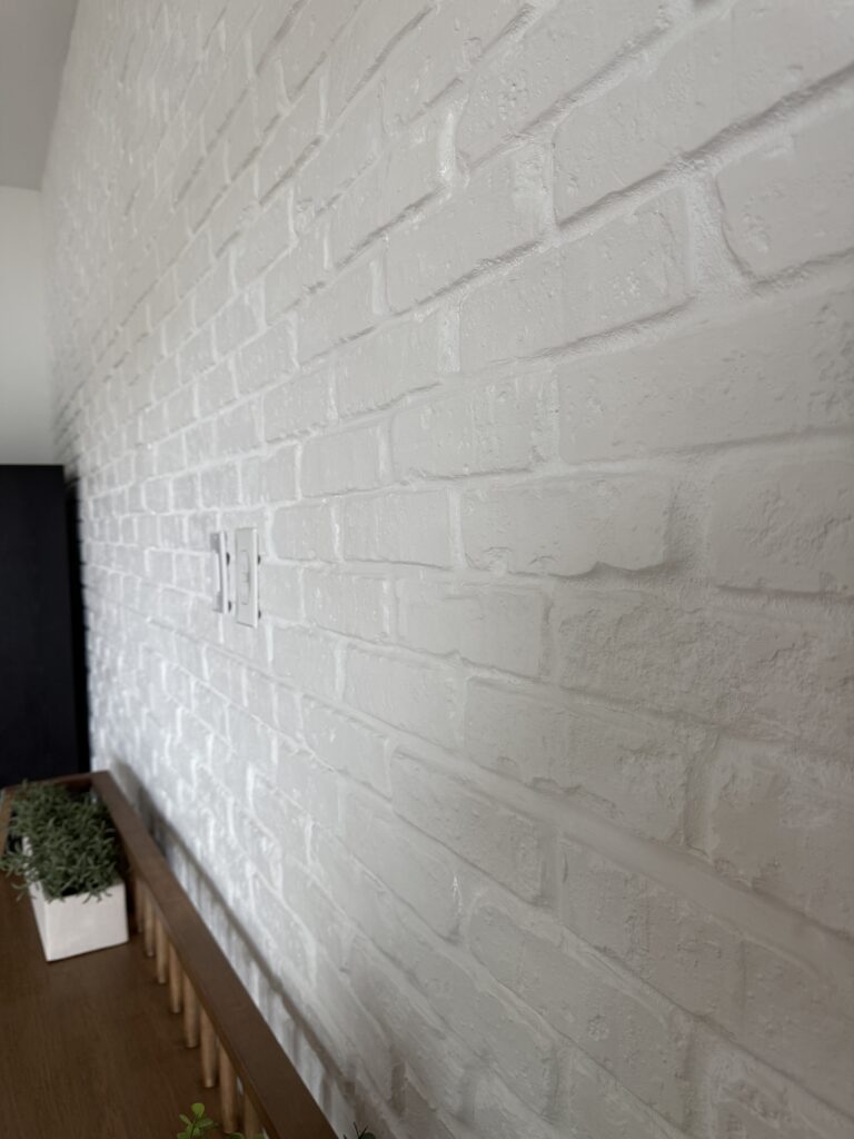 Close-up of white brick accent wall with textured masonry finish and clean painted surface