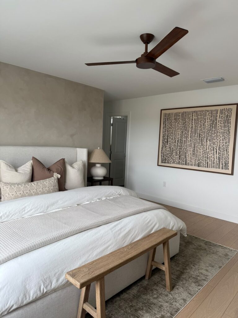 Limewash accent wall in Punta Gorda creating a warm neutral backdrop in a modern bedroom