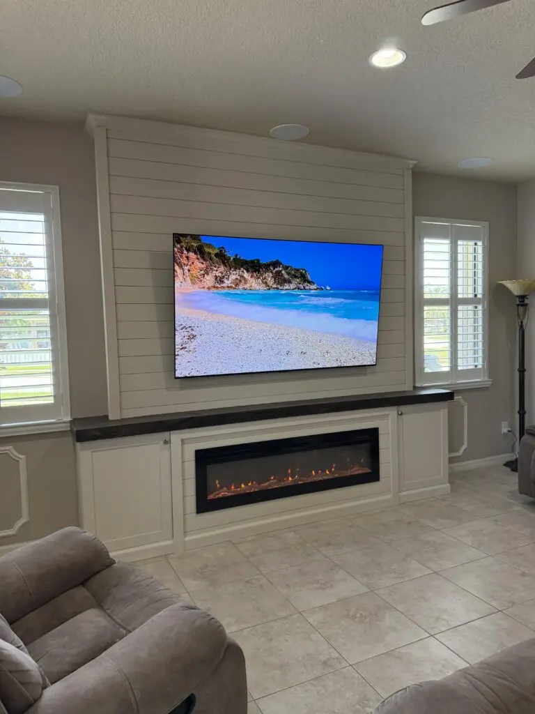 Shiplap fireplace wall Melbourne FL with TV opening and electric fireplace area