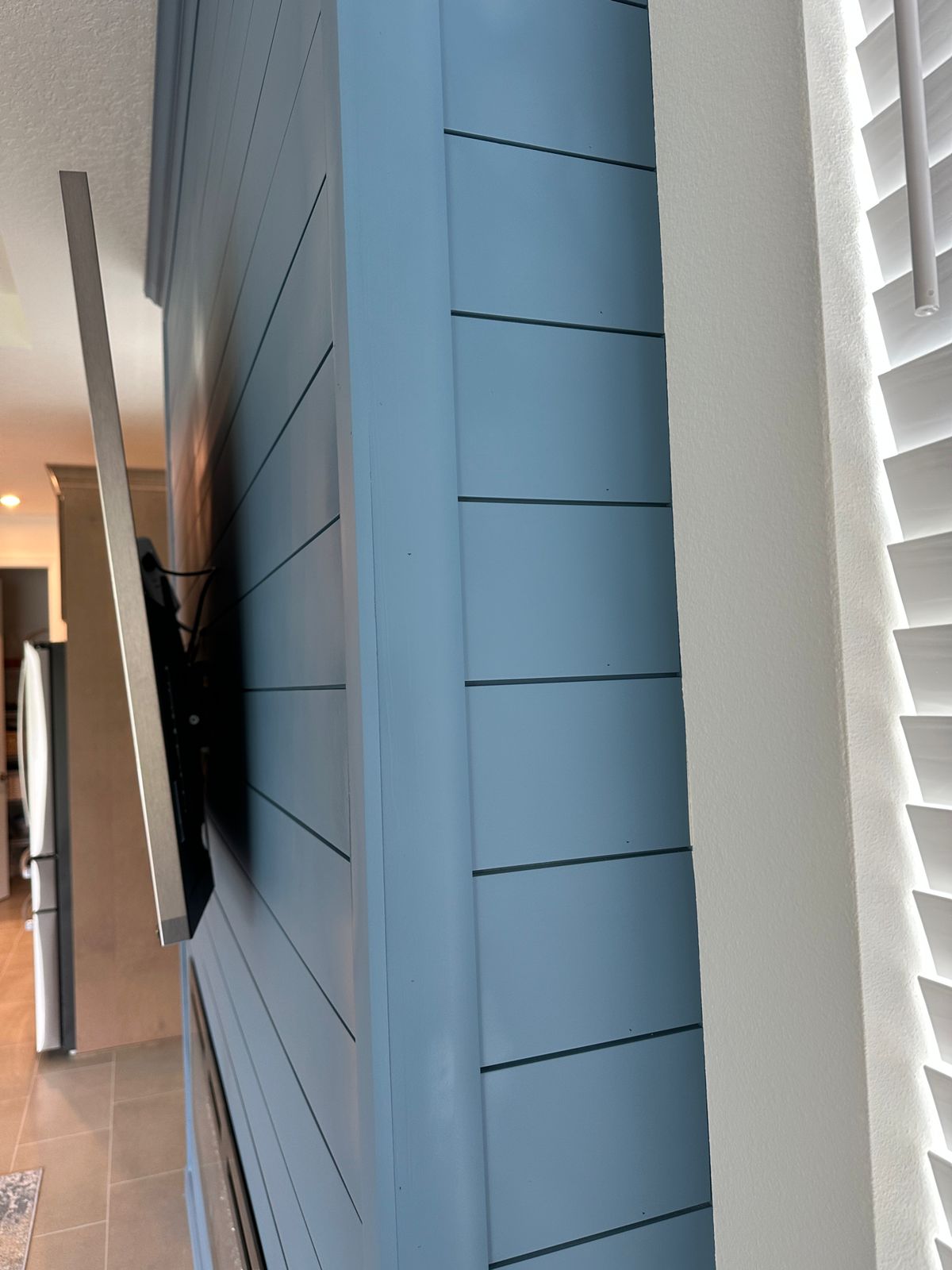Close-up of blue shiplap fireplace wall trim and side finish in Tavares, Florida