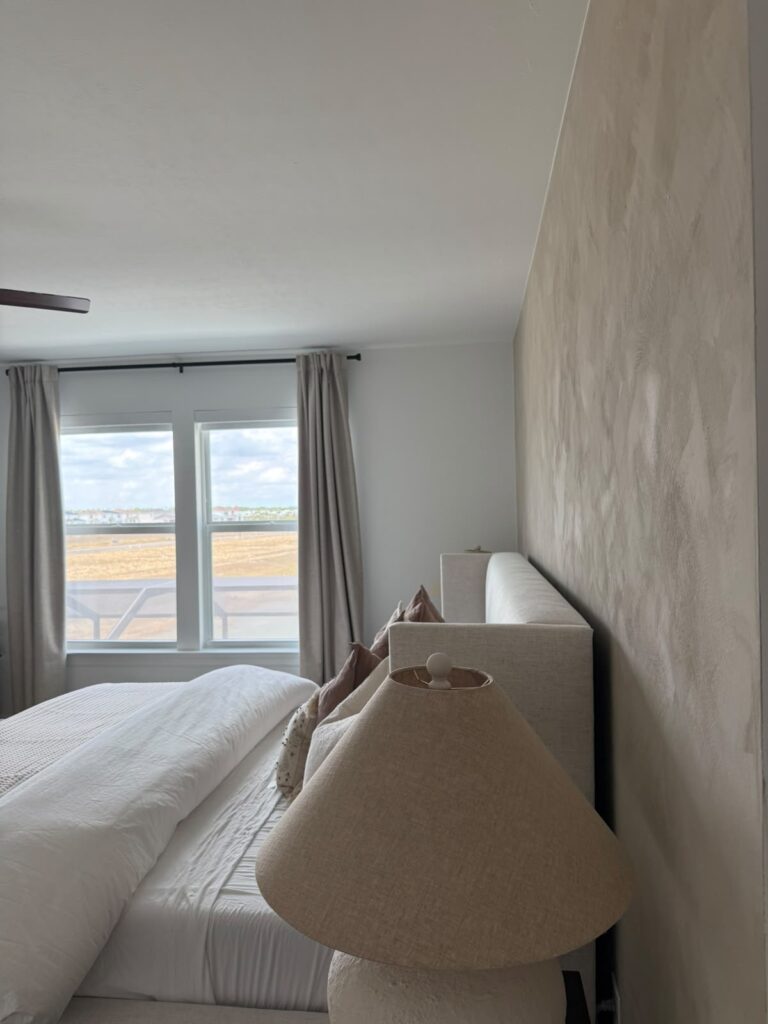 Side view of a limewash accent wall in Punta Gorda with a hand-applied warm neutral mineral finish