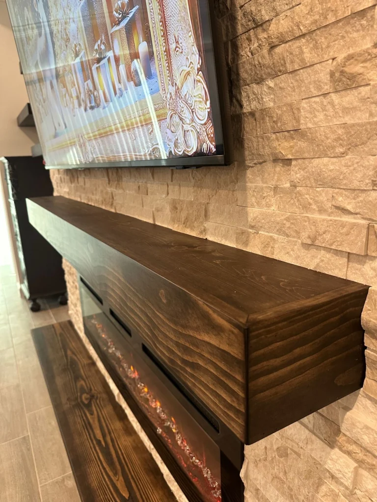 Custom Wood Mantel Detail Dark wood mantel detail on a custom stone fireplace media wall with mounted TV and linear fireplace