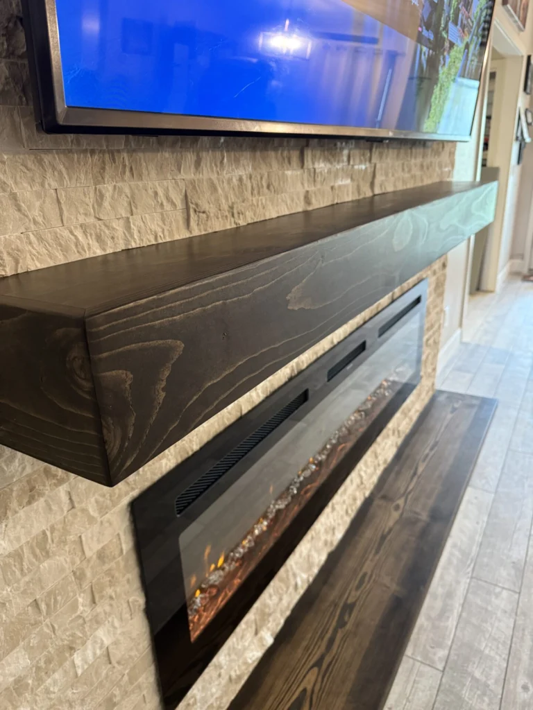 Close-up of handcrafted dark wood mantel on a ledger stone fireplace wall in Sanford, Florida