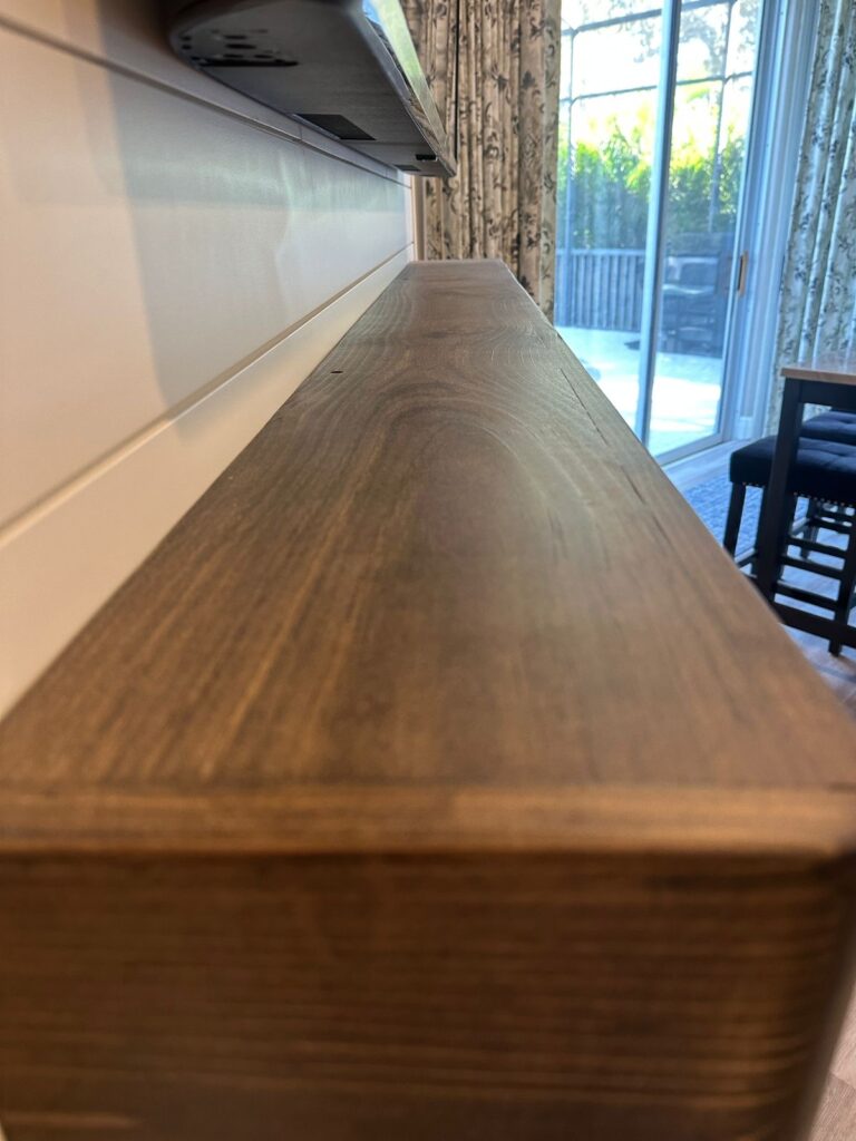 handcrafted-wood-mantel-shiplap-fireplace-clermont.jpg Close-up of handcrafted natural wood mantel for a shiplap fireplace wall in Clermont, Florida