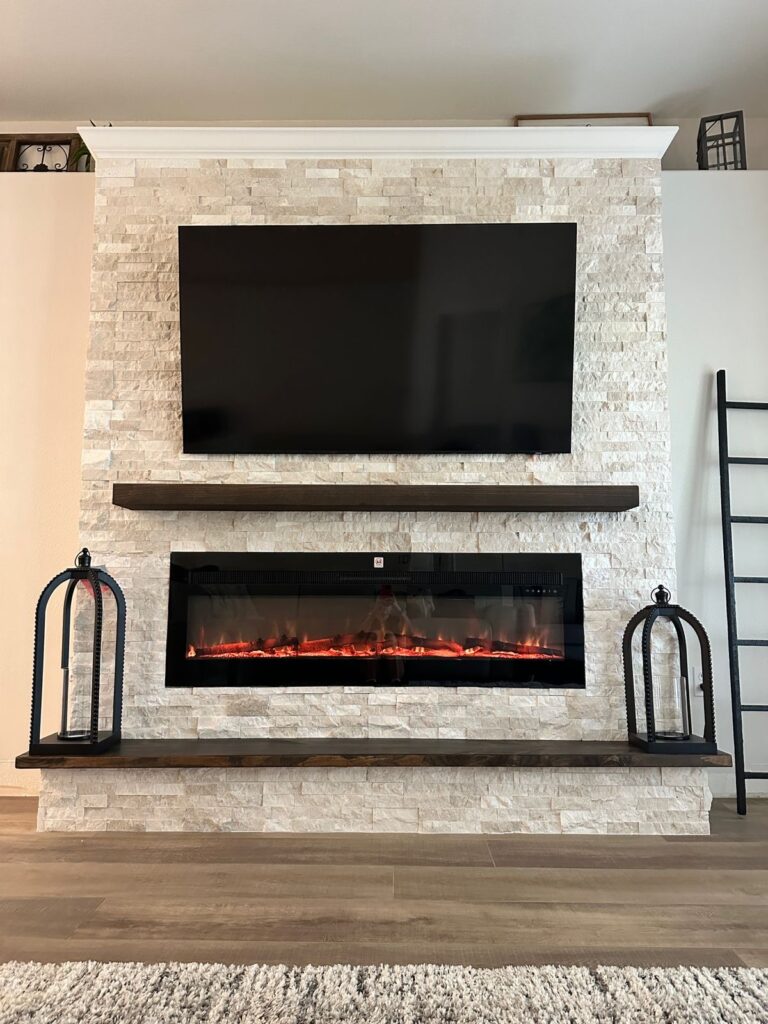 ledger-stone-fireplace-wall-in-melbourne-front-view.jpg Ledger stone fireplace wall in Melbourne with handcrafted wood mantel, built-in hearth bench, mounted TV, and electric fireplace