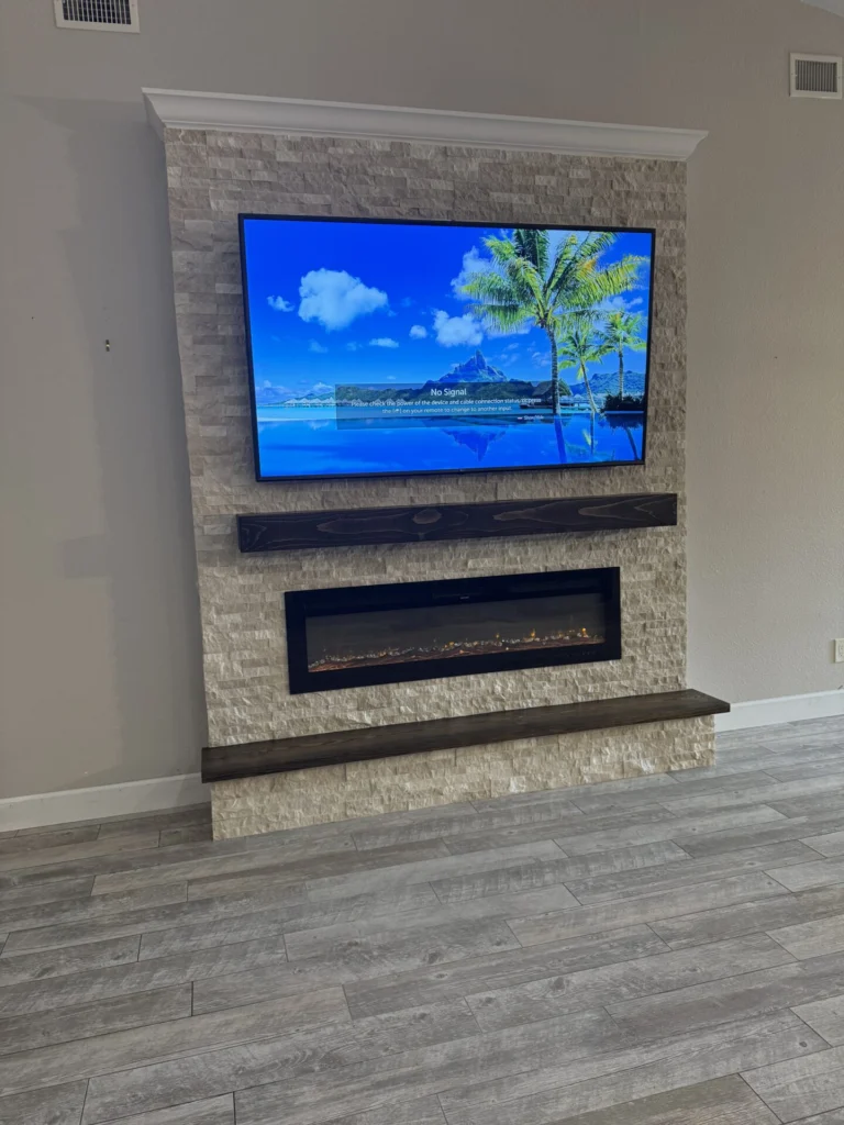 Ledger stone fireplace wall in Sanford with handcrafted wood mantel, matching hearth bench, and linear electric fireplace