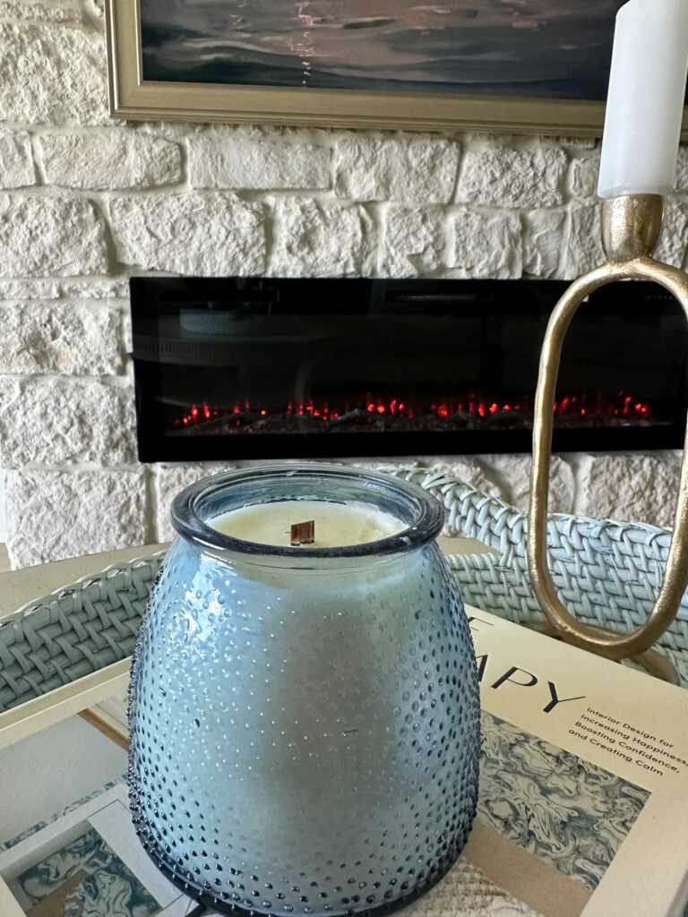 Close-up of limestone fireplace wall Punta Gorda with modern linear electric fireplace and natural stone texture