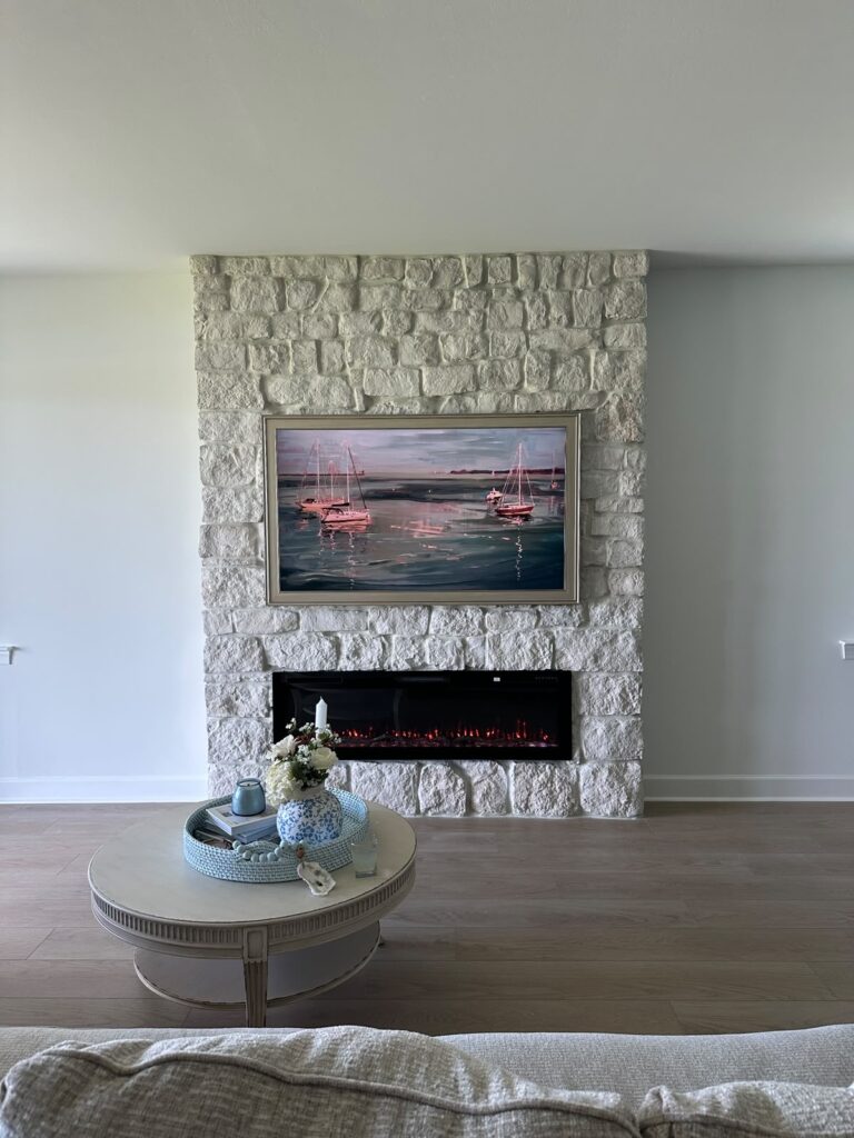 Limestone fireplace wall Punta Gorda with full-height stonework and linear electric fireplace