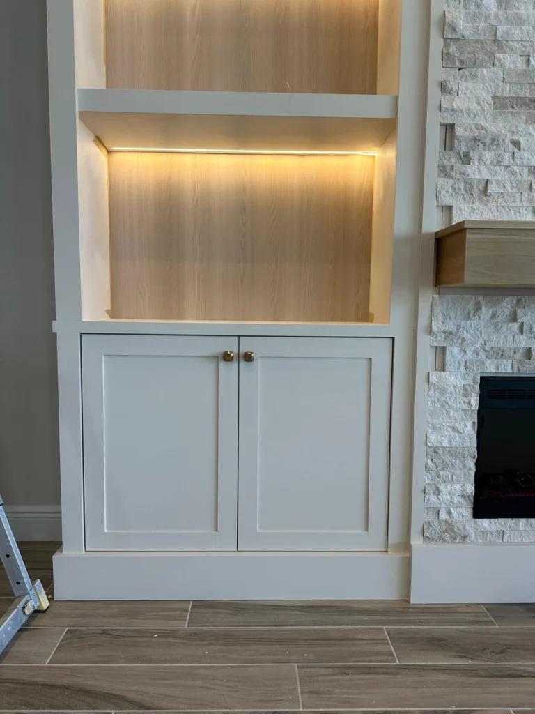 Built-In Cabinet with LED Shelves Orlando Built-in cabinet with LED lighted shelves for a custom fireplace wall in Orlando