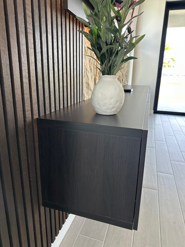 Floating cabinet and wood slat detail for a custom media wall in Orlando
