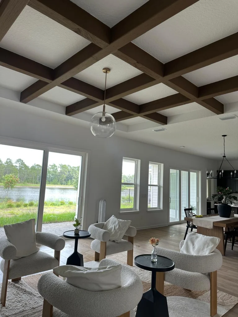 Orlando Living Room with Ceiling Beams and Fireplace Wall Design Orlando living room with ceiling beams, open layout, and custom fireplace wall design inspiration