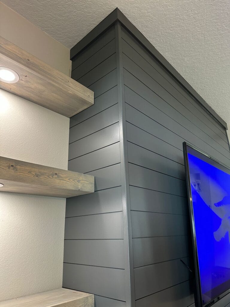 Shiplap media wall in Orlando with floating shelves, TV area, and custom built-in detail