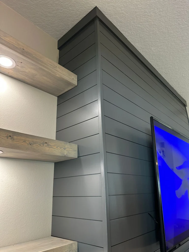 Shiplap Media Wall with Floating Shelves Orlando Shiplap media wall in Orlando with floating shelves, TV area, and custom built-in detail