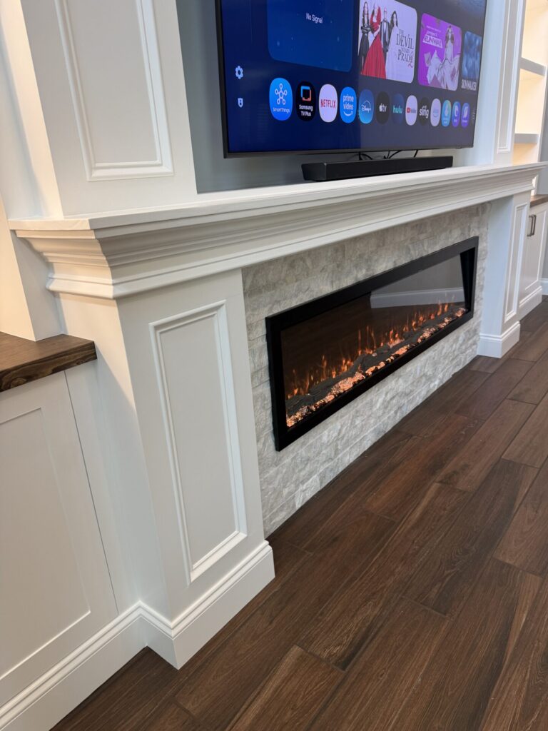 Custom Fireplace Mantel Detail Custom fireplace mantel with furniture-style trim and stone surround