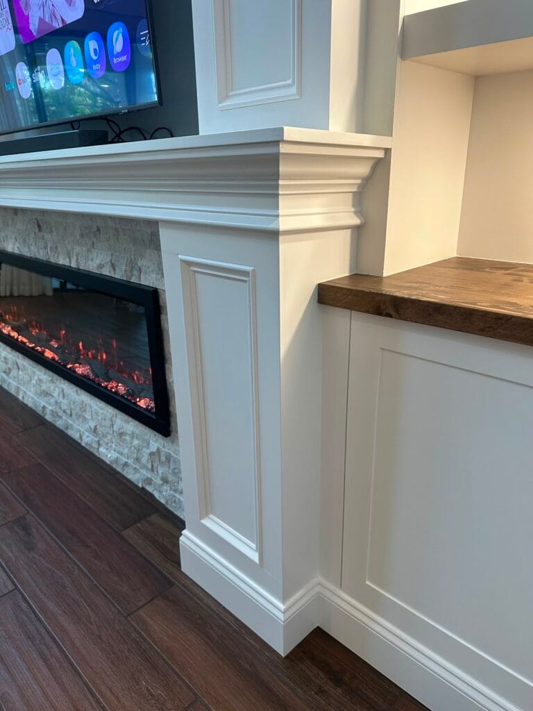 Fireplace Trim and Wood Countertop Detail Furniture-grade fireplace trim with natural wood countertop and stone finish