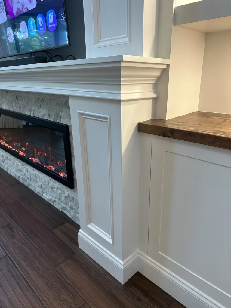 Fireplace Trim and Wood Countertop Detail Furniture-grade fireplace trim with natural wood countertop and stone finish