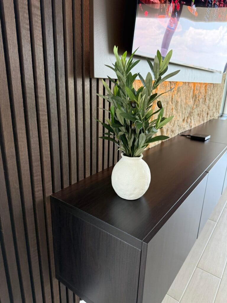 Floating Media Cabinet Detail Floating media cabinet with vertical wood slat accent wall and premium finish
