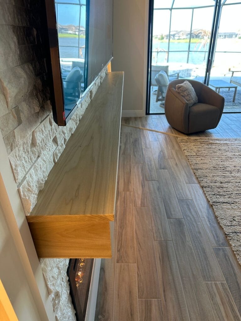 Luxury Ledgerstone Fireplace Media Wall with LED Built-Ins Solid wood floating mantel installed on a custom stone fireplace wall