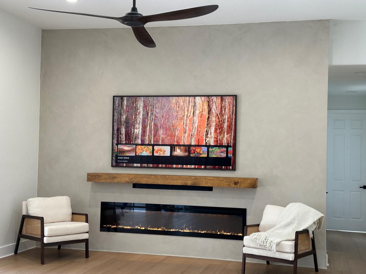 Modern minimal TV media wall in Tampa with linear electric fireplace, wood mantel, smooth finish, and wall-mounted television