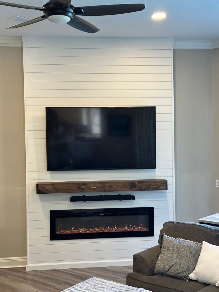 white-shiplap-fireplace-wall-clermont-finished-view.jpg White shiplap fireplace wall with handcrafted wood mantel and linear electric fireplace in Clermont, Florida