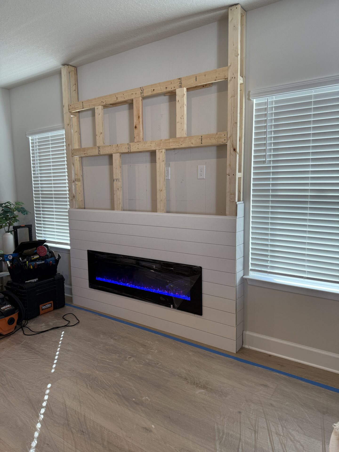 linear-electric-fireplace-installation-white-shiplap-orlando.jpg Installation of a linear electric fireplace in a custom white shiplap fireplace wall in Orlando