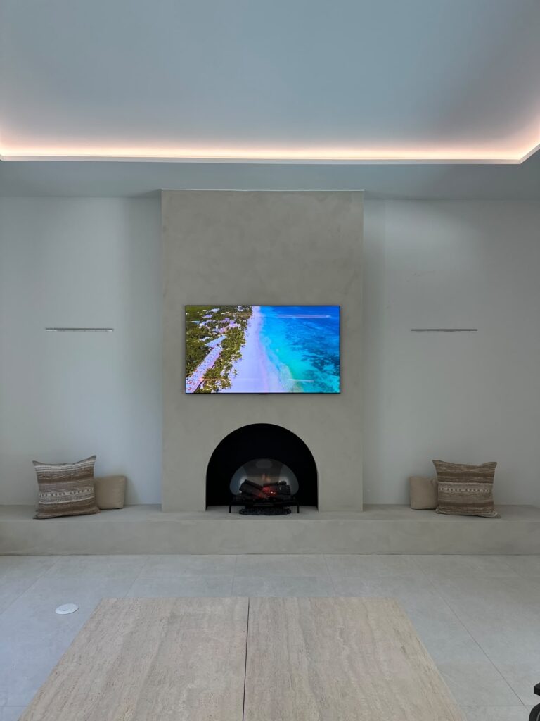 Limewash fireplace wall Boca Raton with arched wood-burning firebox