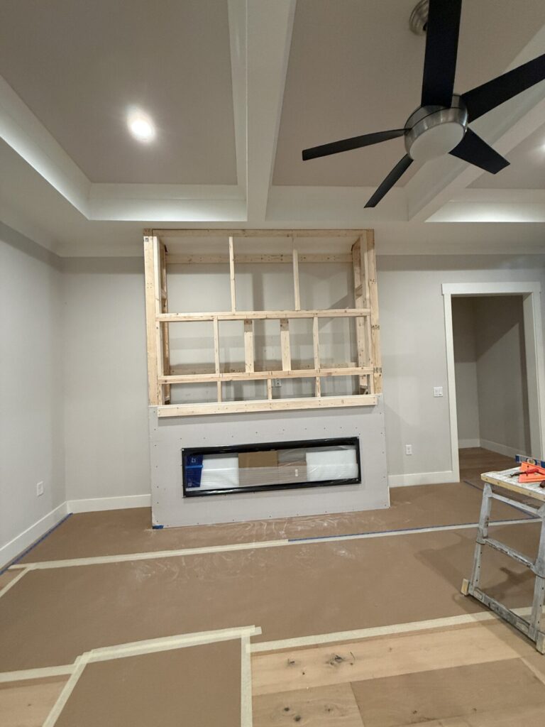 ustom wood framing for an Orlando media wall with TV and linear electric fireplace