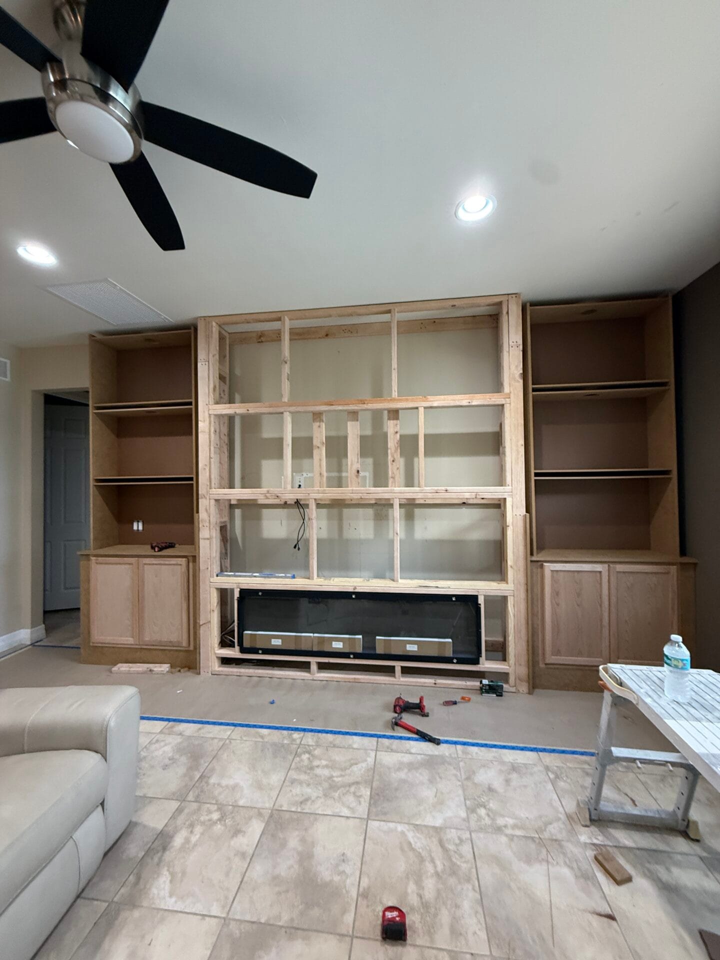 Full media wall framing with unfinished custom built-in cabinets